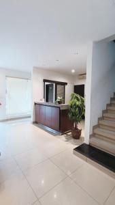 a living room with a staircase and a potted plant at VI Hotel Bandung in Bandung