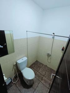 a bathroom with a toilet and a shower at VI Hotel Bandung in Bandung