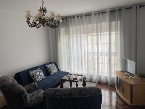 salon z kanapą, krzesłami i oknem w obiekcie Piso O Percebe w mieście Muxia