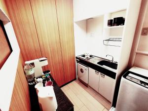 a small kitchen with a counter and a sink at SECRET BASE Station Side in Osaka