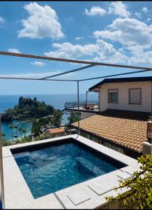 a swimming pool with a view of the ocean at 202 luxury terrace view in Taormina