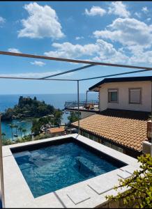 a swimming pool with a view of the ocean at 202 luxury terrace view in Taormina +18 photos