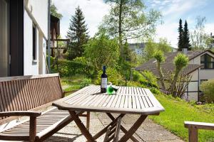 a picnic table with a bottle of wine on it at Ferienwohnung Honberg in Tuttlingen