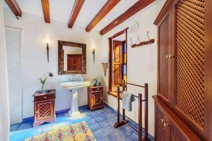 a bathroom with a sink and a mirror at Finca Esperanza mit Privatpool, Whirlpool & Sauna in El Paso +34 photos