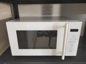 a white microwave with a counter top on top of it at SECRET BASE Station Side in Osaka