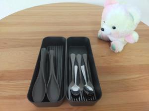 two black plastic utensils and a stuffed teddy bear at SECRET BASE Station Side in Osaka