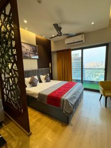 a bedroom with a bed and a large window at Luxury stay by GT Studio in Ghaziabad