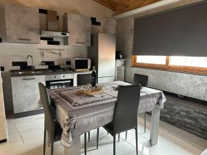 a kitchen with a table and chairs and a kitchen with a tableablish at Testa House in Catania