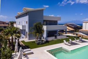 an aerial view of a villa with a swimming pool at Etna Mare Apartments by Wonderful Italy in Augusta
