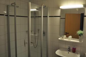 a bathroom with a shower and a sink at Hotel Restaurant Byblos in Nordwalde