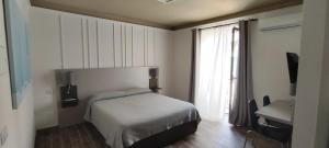 a small bedroom with a bed and a window at Giovita Room and Suite Centro Sicilia in Caltanissetta