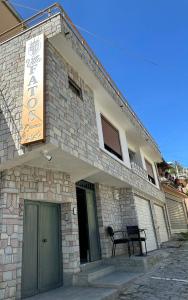 a building with a bench sitting outside of it at Vila Fatos Qama in Berat