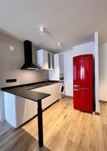 a kitchen with a red refrigerator and a table at Bioca l Apartamento 2 habitaciones I Primera Línea de Playa l Peñíscola in Peñíscola