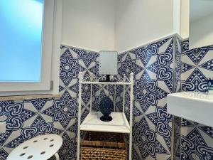 a bathroom with a blue and white tiled wall at Donna Antonietta in Sant'Agnello +26 photos