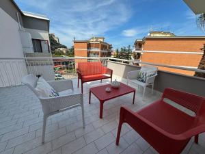 a patio with chairs and tables on a balcony at Donna Antonietta in Sant'Agnello