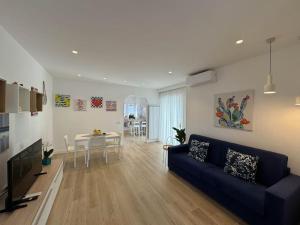 a living room with a blue couch and a table at Donna Antonietta in Sant'Agnello
