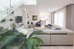 un salon avec un canapé et un escalier dans l'établissement Villa Moroz - BY BEDZY, à Almancil