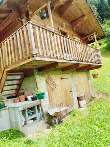 a wooden house with a deck on top of it at Chalet de 3 chambres avec jardin amenage a Beaufort a 8 km des pistes in Beaufort