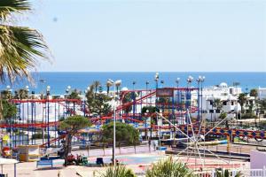 a roller coaster in a park next to the ocean at Appartement prestigieux à Smir Park M'diq in Marina Smir