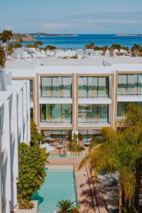 an aerial view of a building with a swimming pool at Nativo Hotel Ibiza in Santa Eularia des Riu