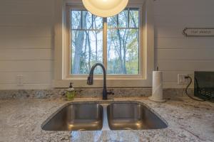 a sink in a kitchen with a window at Belacasa - Hot tub and within walking distance to Douglas Beach! in Douglas +27 photos