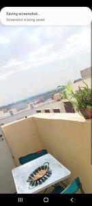 a view of a balcony with a table and chairs at Stay 3 km near to Airport Fes Saiss in Fès
