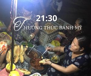 a woman is preparing food at a buffet at Homestay Phủ Cam in Thôn Trường Giang