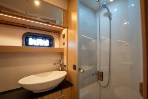 a bathroom with a sink and a shower at GreRos Yacht by ClaPa H.&G Group in Naples