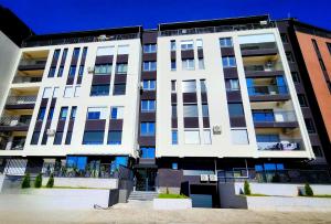 a large white apartment building with windows on it at District Apartment in Bitola