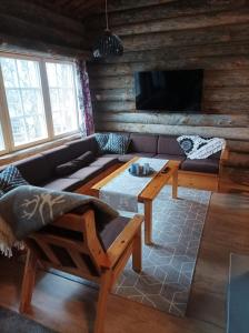 a living room with a couch and a table at Lomaruka in Ruka