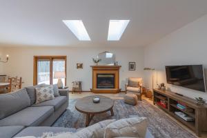 Una sala de estar con un sofá y un televisor. en Pure Hygge - 1 block off Lake, Tranquil & Pet Friendly, en Fennville
