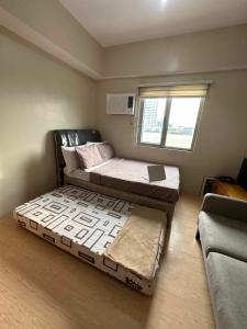 Ένα ή περισσότερα κρεβάτια σε δωμάτιο στο Sunvida Tower Apartment Infront of SM City Cebu