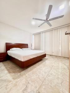 - une chambre avec un lit et un ventilateur de plafond dans l'établissement Casa Isidra, à Rivera