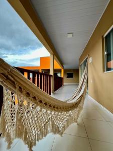 a hammock on the balcony of a house at Chalé Travosa in Santo Amaro