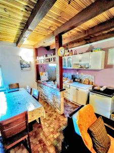 a kitchen and dining room with a table and a counter at 3 bedrooms chalet with enclosed garden and wifi at Herceg Novi 2 km away from the slopes in Herceg-Novi