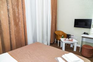 Sahil Ark Hotel Baku tesisinde bir odada yatak veya yataklar