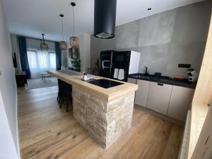 a kitchen with a stone island in the middle of a room at Cornelia Suites 01 in Santander