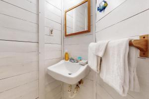 a white bathroom with a sink and a mirror at Town of South Bethany --- 137 Evergreen Rd in South Bethany +18 photos