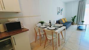 a kitchen with a table with chairs and a living room at Candelaria ocean views in Candelaria +23 photos