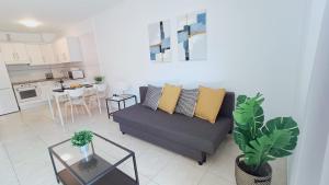 a living room with a couch and a table at Candelaria ocean views in Candelaria