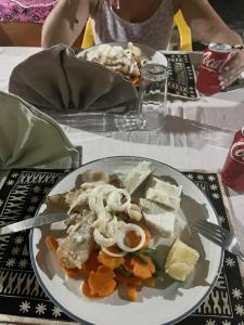 a plate of food with mushrooms and vegetables on a table at Voyager Retreat Homestay in Nanuya Lailai