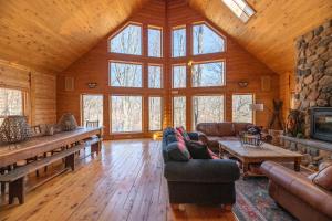 a living room with couches and a fireplace in a cabin at Swan Lodge - Walking distance to downtown Saugatuck - Modern Cabin Getaway! in Saugatuck