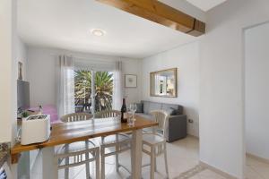 a dining room and living room with a table and chairs at Nido Andrea in San Isidro
