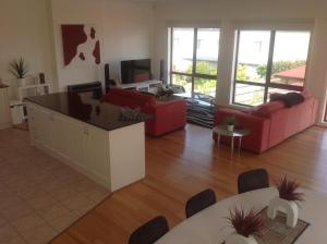 a living room with two couches and a tv at Townhouse Chapel Street in Cowes