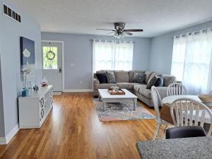 a living room with a couch and a table at School Street Haven - 4 bedroom 2 bath sleeps 10 and is centrally located to downtown South Haven in South Haven