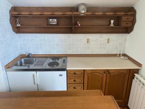 a kitchen with a sink and a stove at Guesthouse Vionica in Međugorje