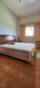 a bedroom with a large bed and a window at Sitio localizado na cidade São José do Rio Preto, Espaço é ideal para Aniversários e Confraternizações. in Sao Jose do Rio Preto