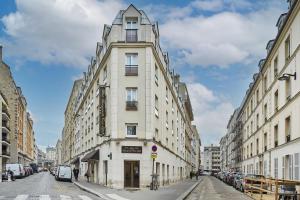 パリにあるホテル ボーグルネール トゥール エッフェルの市道の白い高い建物