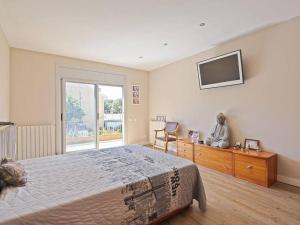 a bedroom with a bed and a television on the wall at Villa Marítima in Pineda de Mar in Pineda de Mar +20 photos