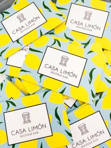 a group of cassia lincoln labels on yellow lemons at Casa Limon, boutique Bed and Breakfast, Andalucia in Alhaurín el Grande